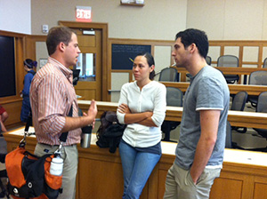 From right: HLS Advocates for Human Rights Co-Presidents James Tager, JD '13, and Ana Lise Feliciano Hansen, JD '13, speak with a student at a Human Rights Program event.