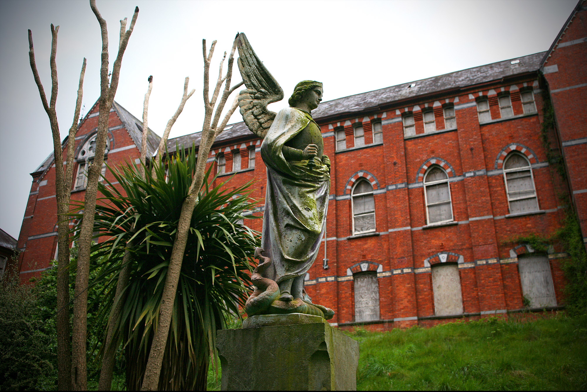 Outside, an angel statute stands in front of the building.