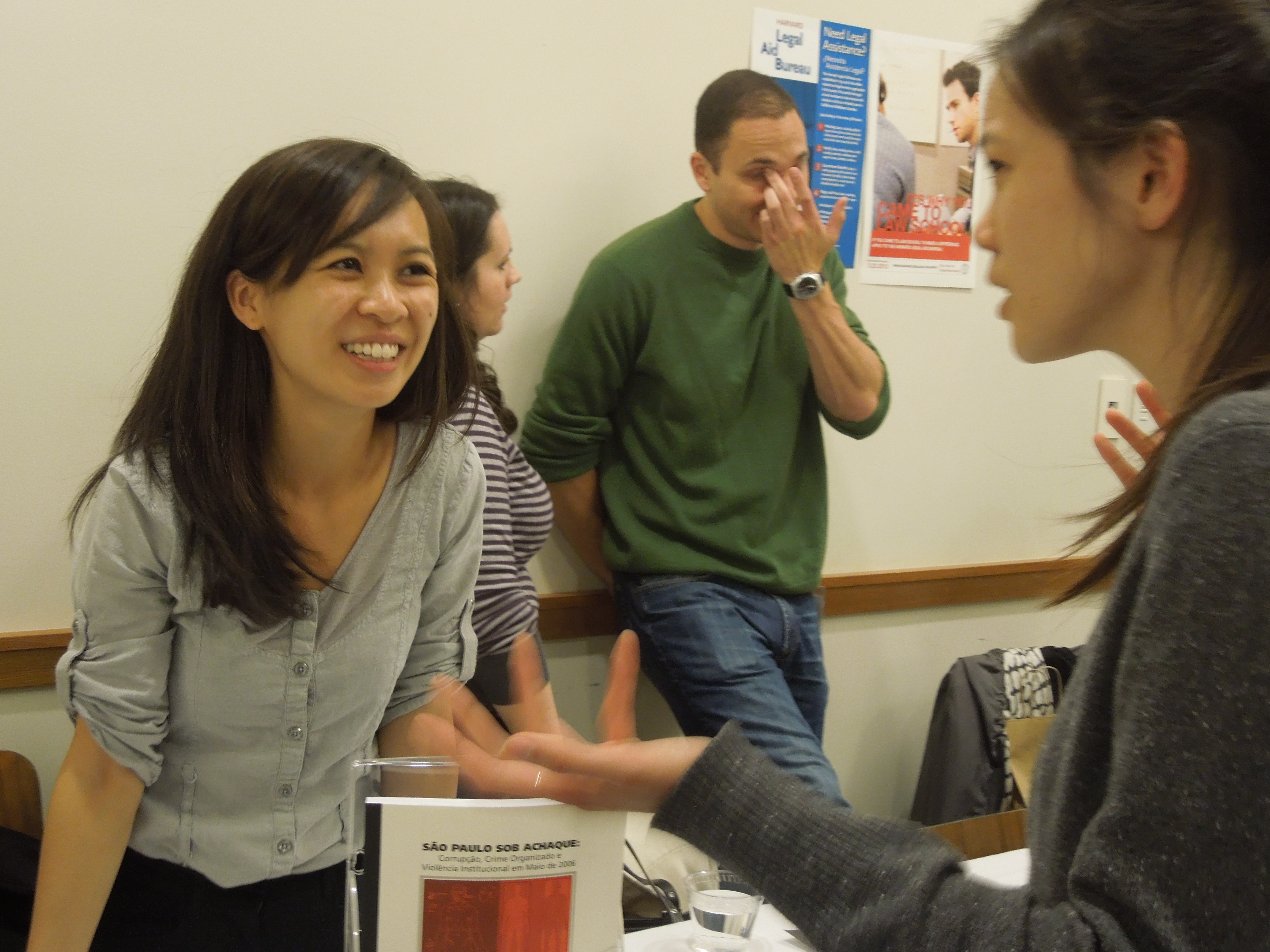 A woman smiles as she speaks to a student.