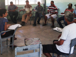 Atzin Gordillo, at left, an organizer with ProDESC, gives a presentation to the workers of the Sinaloa Coalition about their rights under the H-2 visa program. 