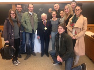Students smile and pose around Ben Ferencz.