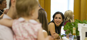 A clinical instructor smiles at a banquet table.