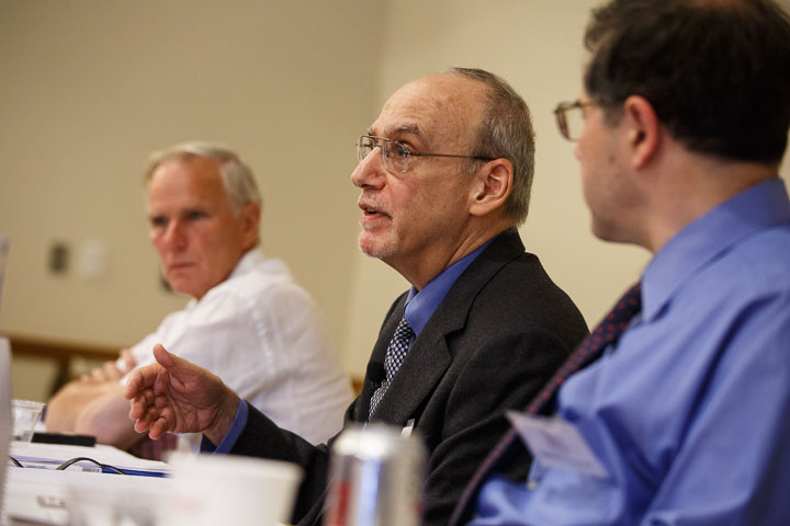 Gerald Neuman speaks at an event, with Philip Alston looking on.