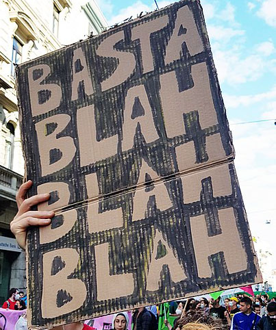 Person holding sign at protest that says Blah Blah Blah