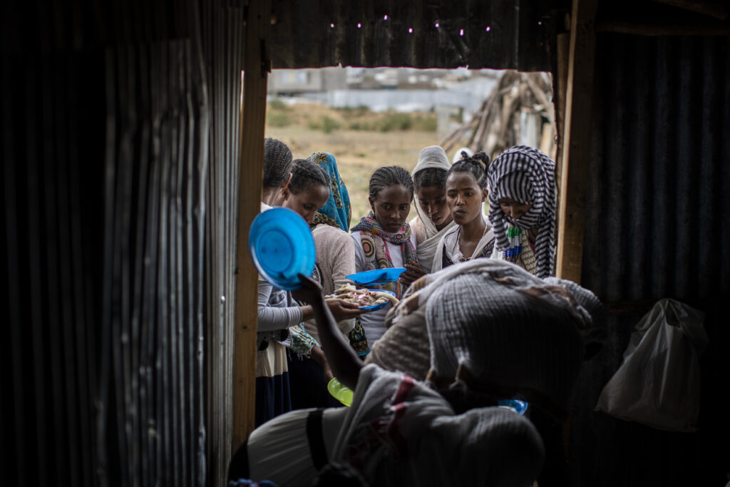 Tigrayans stand in line to receive food donated by local residents at a reception center for the internally displaced in Mekele, in the Tigray region of northern Ethiopia, on May 9, 2021. Credit: AP. 