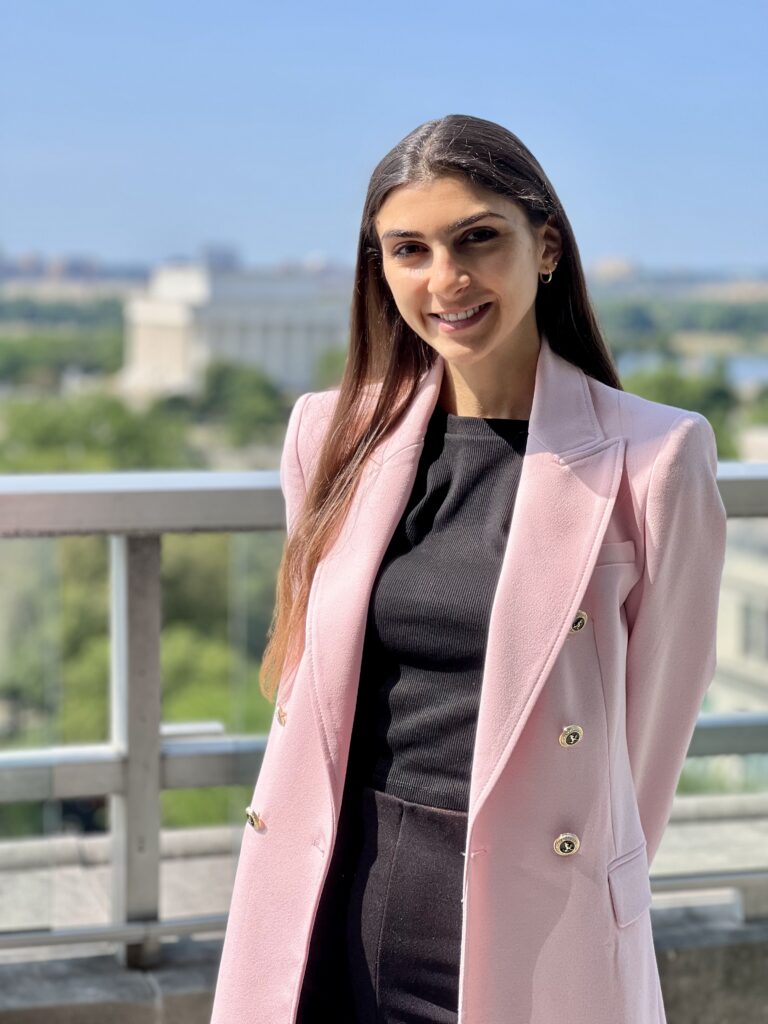 Photo of a woman in a pink blazer.